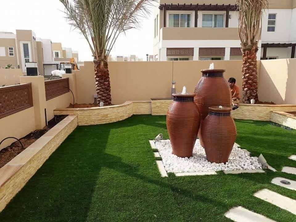 Garden softscape with decorative water feature pots
