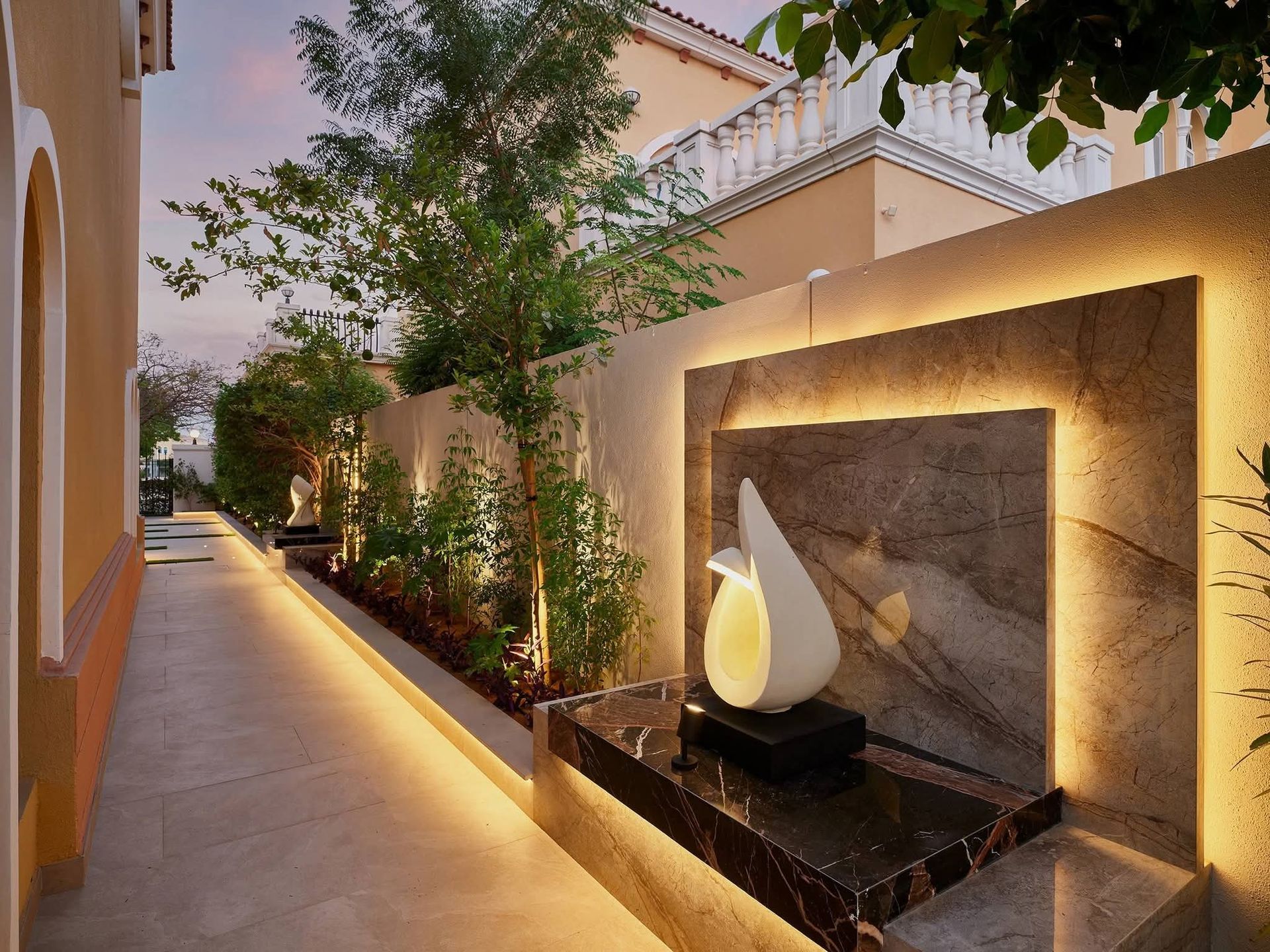 Villa side walkway landscaping with outdoor lighting and planting in Abu Dhabi