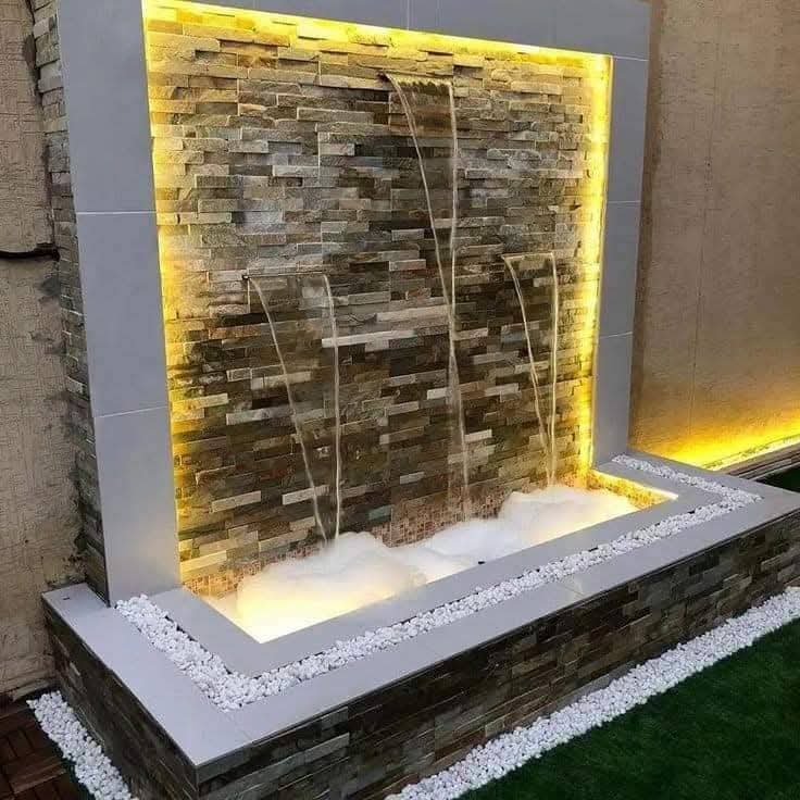 Backyard waterfall feature with lighting