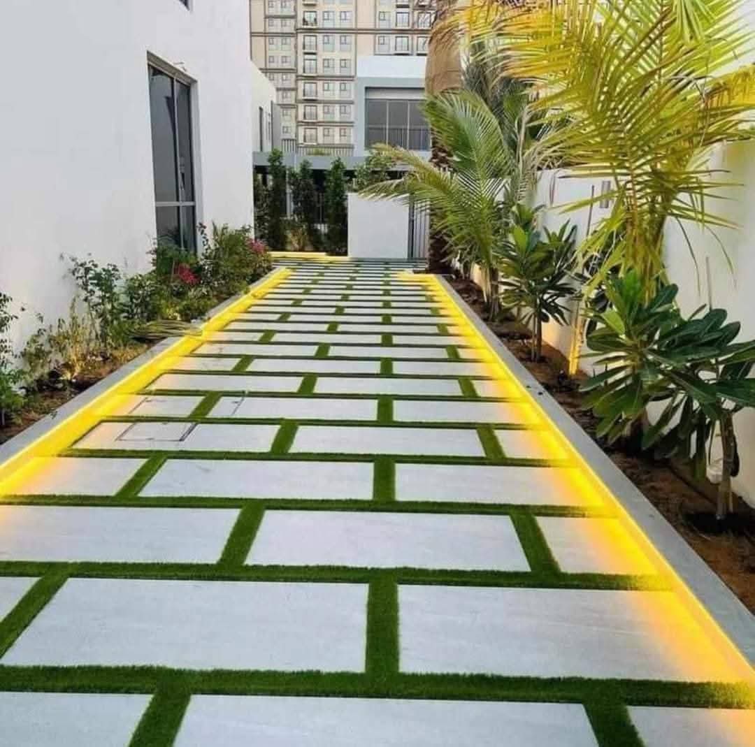 Interlock paving driveway and garden edging with plants in Abu Dhabi villa